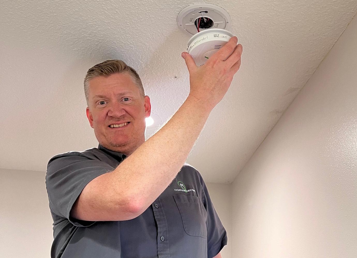 Electrician checking fire alarm