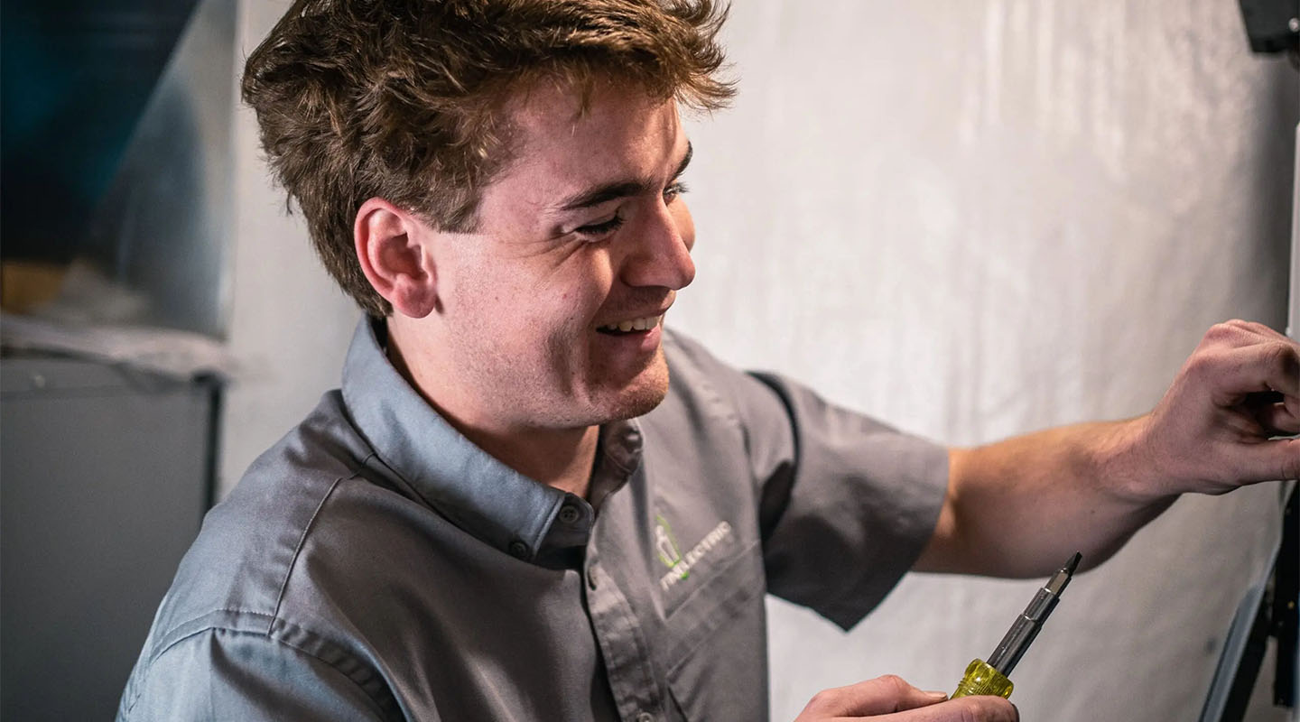 Happy electrician fixing cables