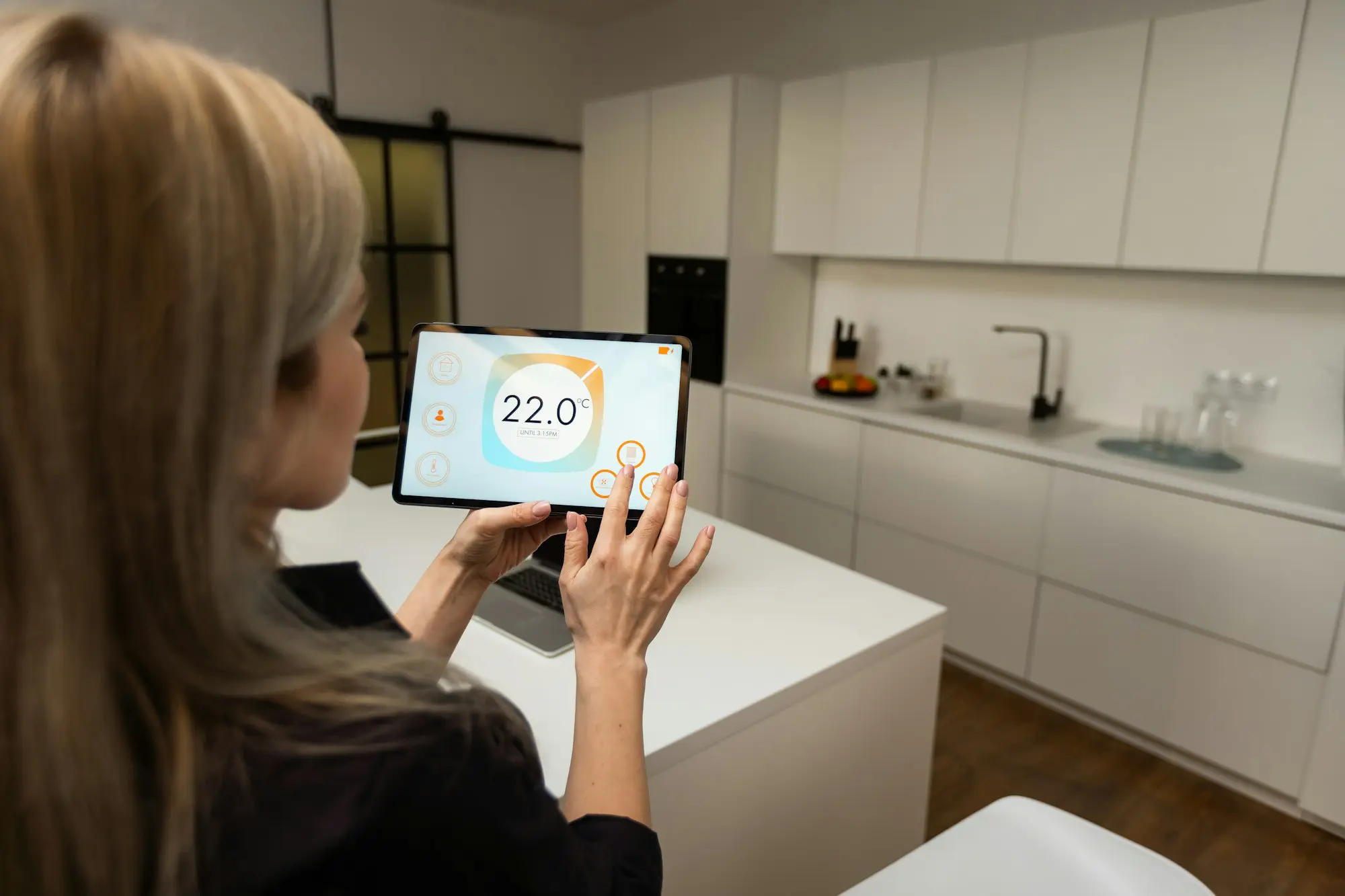 Woman reviewing tablet inside smart home