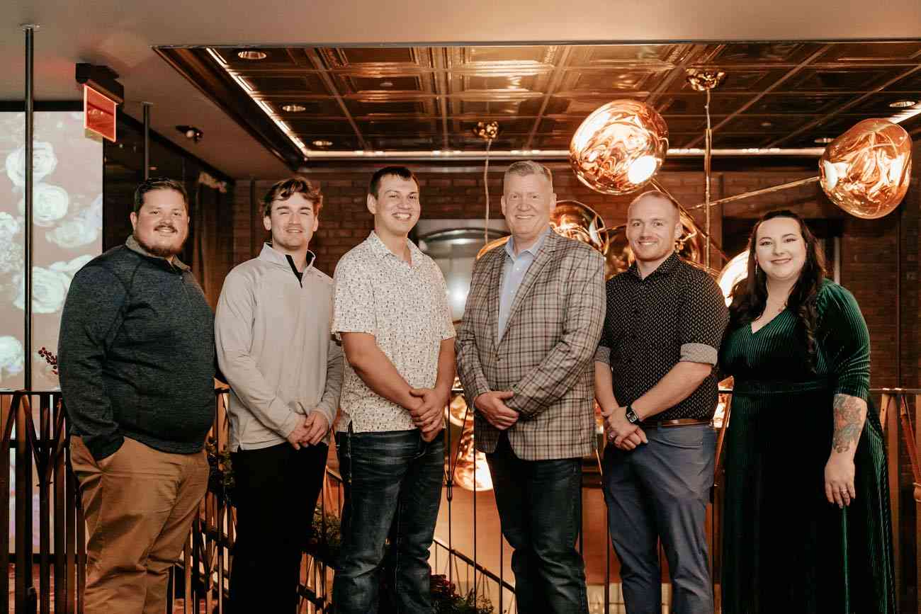 The Coffin Electric team is celebrating a company holiday party, highlighting community values in Grimes, IA.