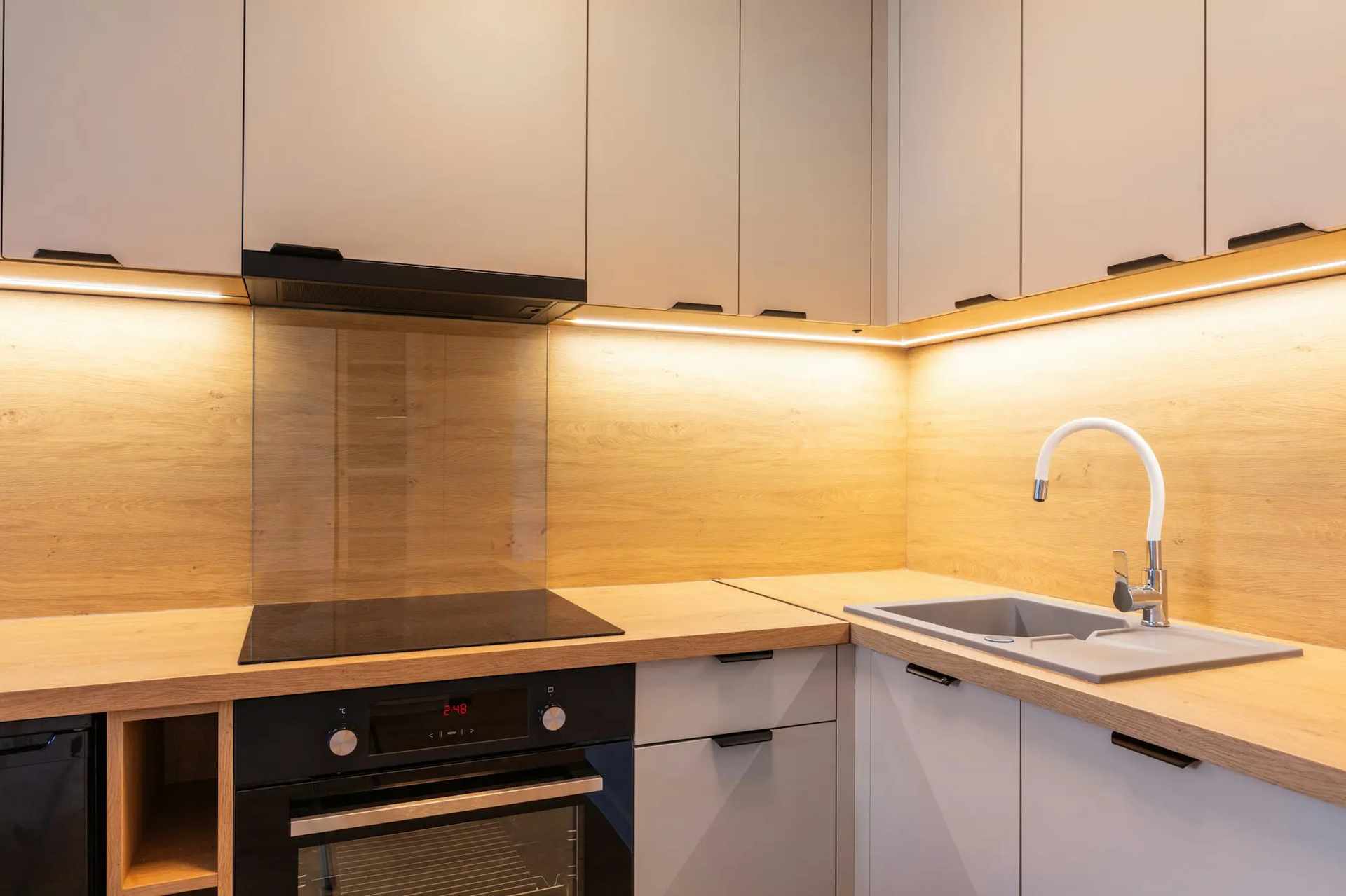 Kitchen featuring under-cabinet lighting, sink, stove, and oven in Grimes, IA
